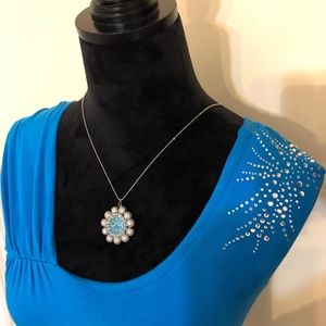Turquoise top with shoulder bling.